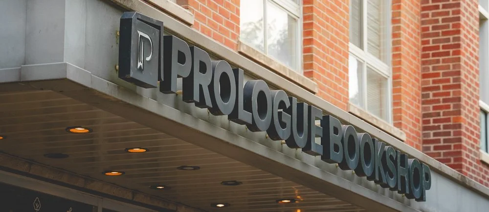 Prologue Bookshop sign on the brick storefront in Columbus