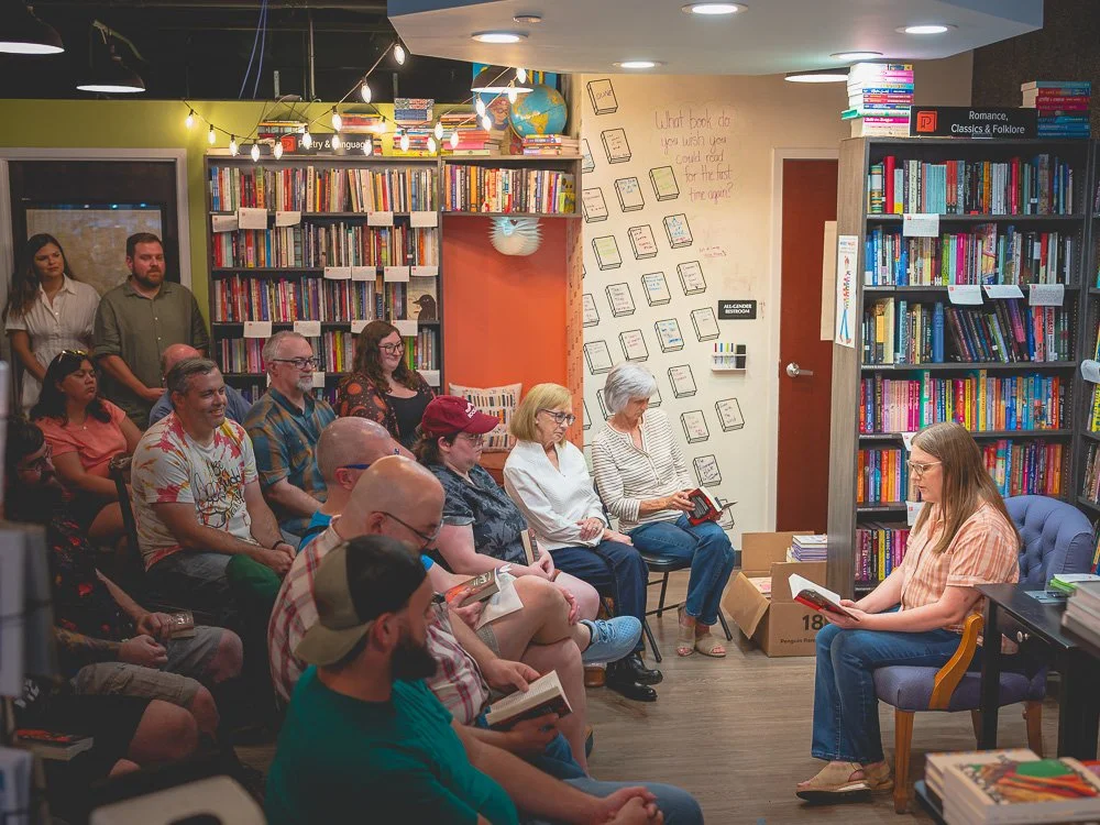 Bonnie Quinn reading aloud to an attentive bookstore audience