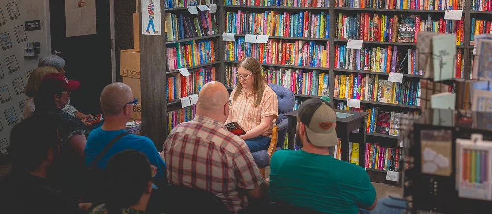 Author Bonnie Quinn reading to an audience inside Prologue Bookshop in Columbus