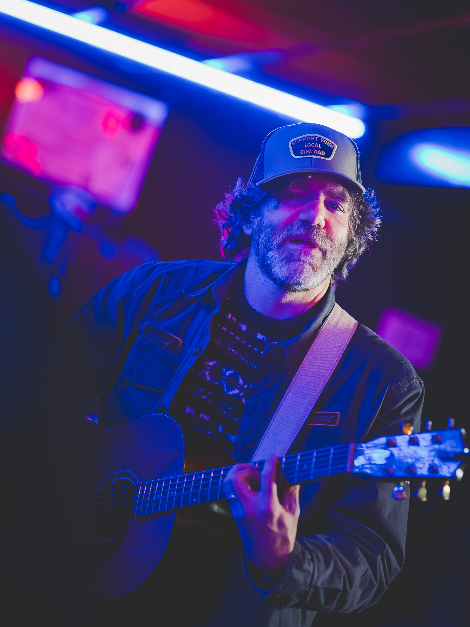 A guitarist under neon