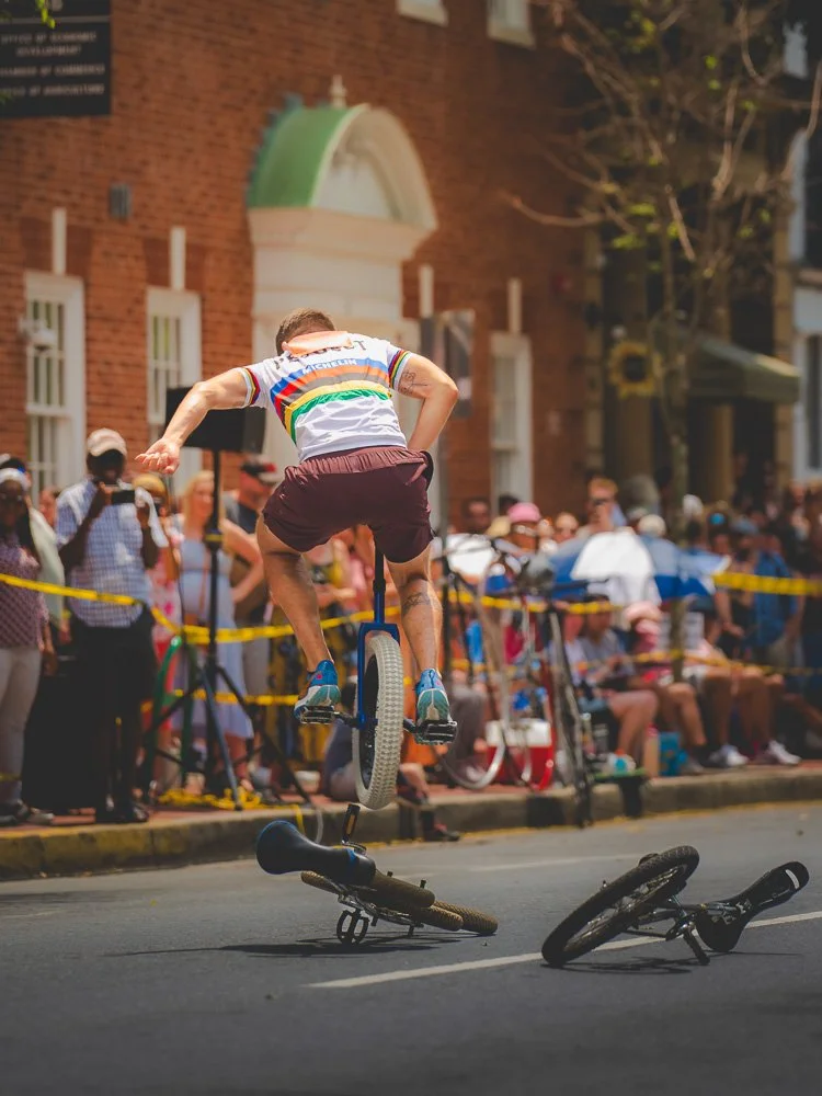 A unicyclist jumping over two bicycles during the event