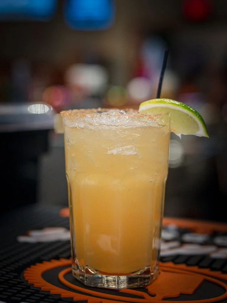 A citrus cocktail resting on the bar