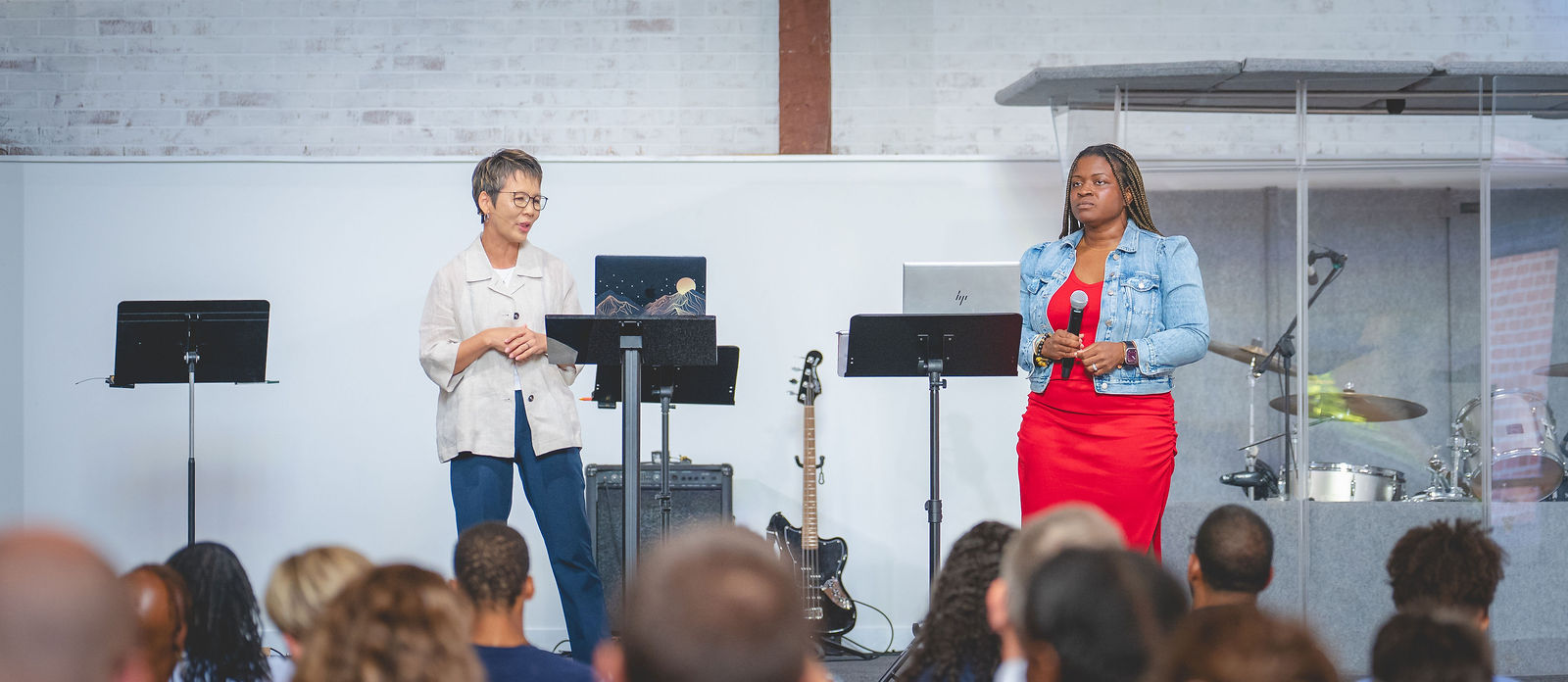 Sanctuary Columbus leaders speaking to the congregation during a Sunday service