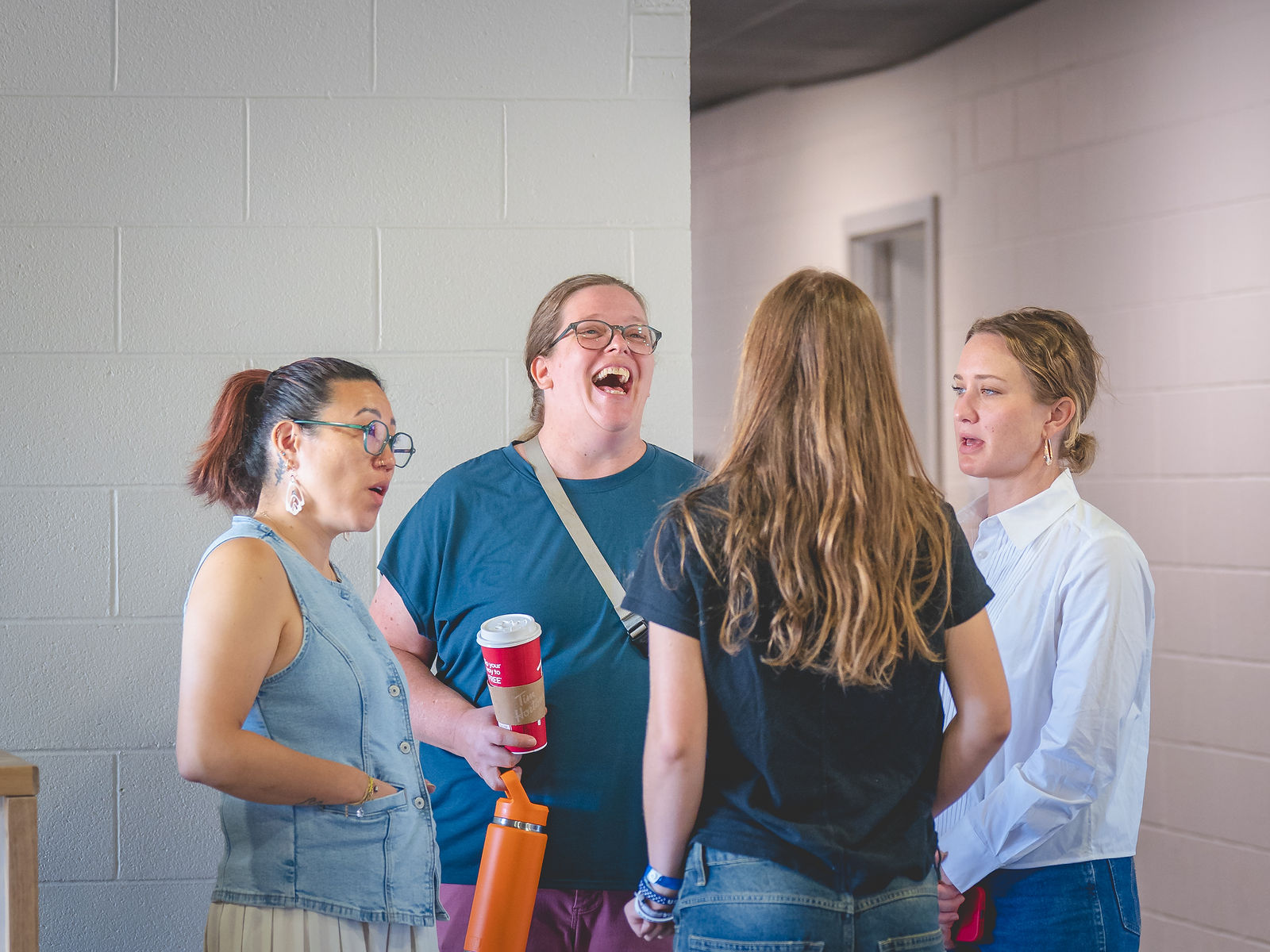 Adults talking and laughing during a Sanctuary Columbus gathering