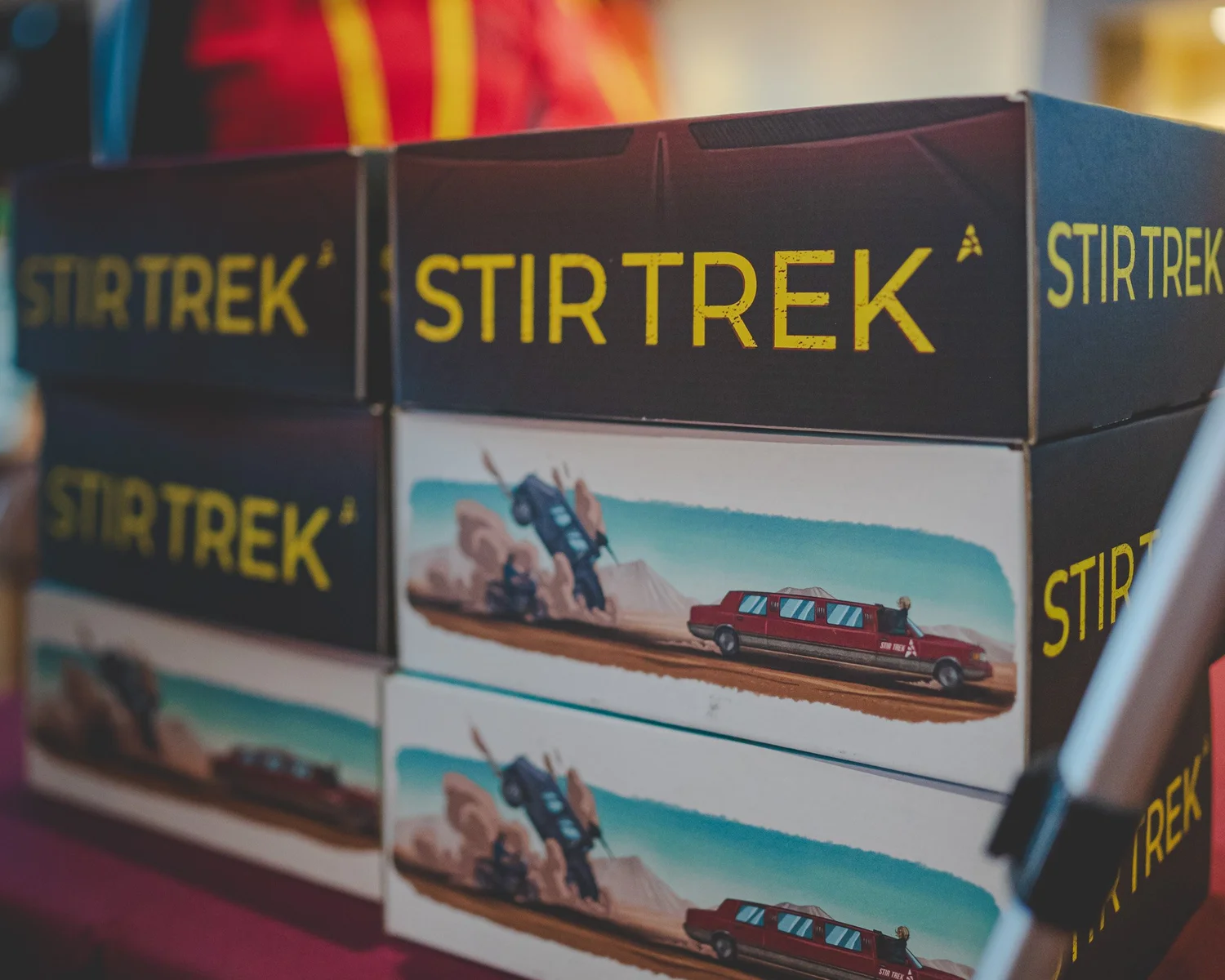Branded Stir Trek boxes stacked at the conference