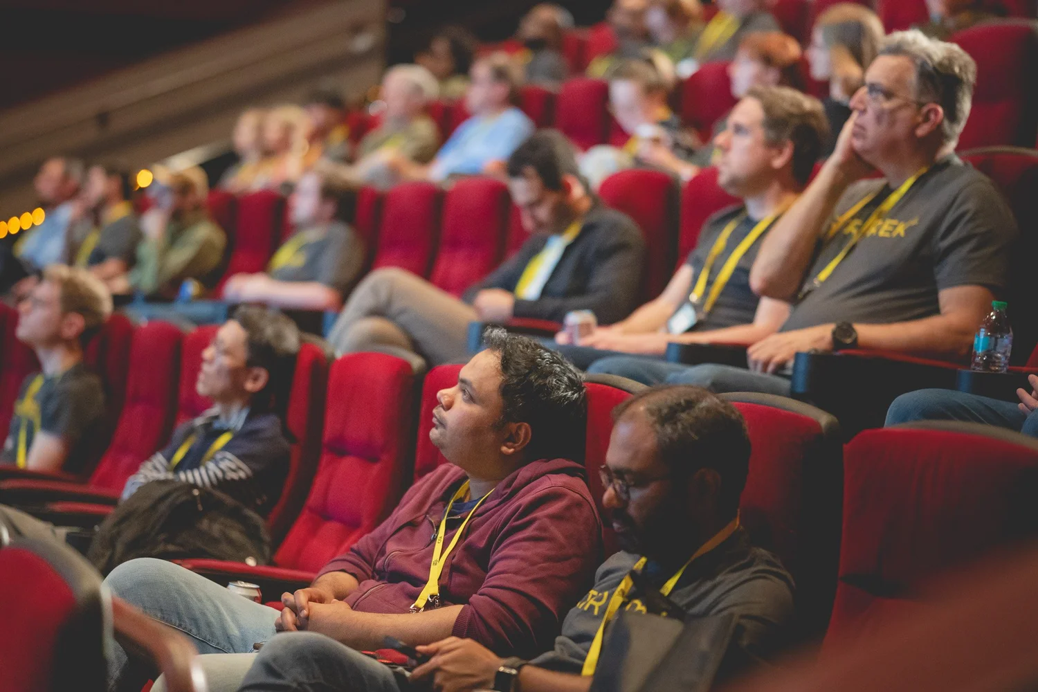 Stir Trek attendees listening from red theater seats